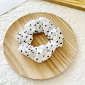 Chic white scrunchie with black polka dots on fabric, placed on a wooden tray - White with Coffee Polka Dots