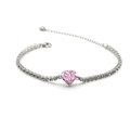 Detail of a pink heart-shaped crystal set in a silver-toned tennis bracelet with zircons - Pink