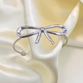 Minimalist silver bow open bangle with bead detail on elegant satin fabric background - Bowknot Bracelet-Silver