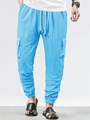 Macro view of bright blue cargo pants showing drawstring waist and textured fabric - Light Blue