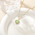 Close-up of green heart crystal pendant with micro-pave diamonds on a gold chain - Light Green Pendant Necklace