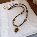 Macro view of vintage gold-plated necklace featuring oval tiger eye stone pendant - Drop Style (41#) / Gold-Coffee-Black