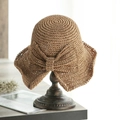 Cappello a secchiello in paglia kaki scuro con grande fiocco su supporto in legno - M (56-58cm) / Caffè Chiaro