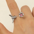 Detail of adjustable hummingbird and pink crystal flower ring on model's finger - Hummingbird With Pink Rhinestone Style (0229)