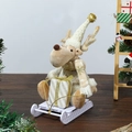 Detailed view of a plush Christmas reindeer figurine on a white sleigh with a gift box - Gold Skiing Figurine Deer