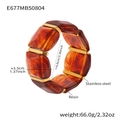 Detailed view of amber resin cuff with gold stainless steel accents and dimensions - 60mm / Amber (E677)