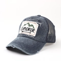 Side view of washed blue trucker hat with Explorer patch and breathable mesh - Adjustable / Navy Blue