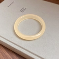 Minimalist round cream glazed bracelet with a translucent texture on a book - Agate Texture/Round Bangle / Beige