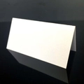 Classic white V-fold place cards with matte finish on black reflective surface - White