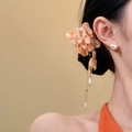 Close-up of elegant fabric floral hair clip with dangling pearl tassels on model - Duckbill Hair Clips / Orange