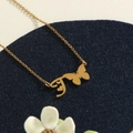 Gold stainless steel necklace featuring a butterfly with letter J pendant design - Gold T