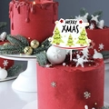 Close-up of Merry Xmas acrylic cake topper with cartoon trees on festive red cream cake - Christmas Tree-White