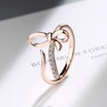 Rose gold adjustable bow ring with sparkling vertical line of eight cubic zirconia stones - Adjustable Open / Rose Gold