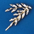 Macro detail of golden leaf hair clip featuring sparkling rhinestones on blue fabric - HS-J6765G