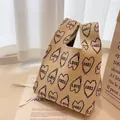 Beige knitted tote bag with pink pixel heart patterns and LOVE text in stylish setting - Apricot Heart