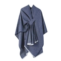 Detail of dark blue knit poncho featuring a front knot design and white tassel fringe - Navy Blue