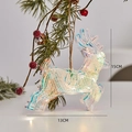 Detail showing 15cm iridescent LED Christmas reindeer ornament on pine branches - Glowing Reindeer