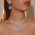 Luxury silver flower jewelry set with water drop rhinestones worn by a model - Pear-Shaped Rhinestone Style (DTN14027123S)