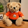 Light brown plush teddy bear wearing an orange panda hoodie and navy blue shorts - Panda Holding Bamboo Hoodie Set / Orange