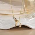 Macro detail of bird pendant with vibrant colorful zircon stones on golden chain - FN0141 Rainbow Gemstone Hummingbird