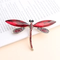 Elegant gold-tone dragonfly brooch featuring dark red glass wings and crystal accents - Red