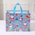 Blue Christmas non-woven gift bag with snowman and Santa prints for party favors - Blue Holiday Wishes Party