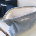 Close-up of corduroy makeup bag with zipper, inner lining and simple wish label - Light Blue