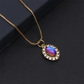 Macro shot of gold necklace with oval pendant featuring blue-purple stone and micro zircons - Blue and Purple