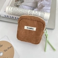 Detail view of a mini brown corduroy organizer bag with zipper and green pull cord - Brown