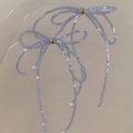 Detailed macro shot of handmade iridescent purple beaded bow studs with golden center beads - 45# Blue Silver Post