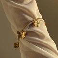 Vintage gold butterfly charm bracelet set against a white mesh sleeve background - 16+4cm Bracelet