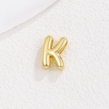 Macro view of 3D puffy balloon style golden letter K pendant with polished finish - Letter K / Gold