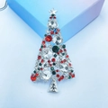 Macro detail of Christmas tree brooch with silver metal and multicolor crystals - Shiny Rhinestone Christmas Tree