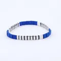 Detailed close-up of blue matte beads and silver metal beads on a stretchy bracelet - Blue Silver