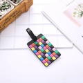 Colorful geometric grid luggage tag with black strap and buckle on white grid - Mosaic