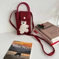 Close-up of dark red knitted crossbody bag with a white bear pattern and silver buckle - Wine Red Bear