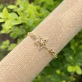Detailed macro view of 18K gold plated infinity chain bracelet with star pendant - Pave Gold Stars