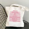 White canvas tote bag featuring red Nurse Rules print on a modern black metal chair - Style C17 (No Inner Pocket/No Zipper)