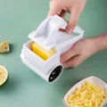 Manual rotary cheese grater with white plastic housing and sharp stainless steel drum - Single Use (PP Bag)