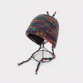 Rainbow knit monster hat with horns and braided earflaps for winter warmth - One Size / Machine Woven Rainbow Hat