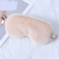 Soft faux fur sleep eye mask in light orange with elastic silk strap on plush background - Light Khaki