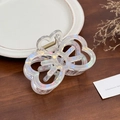 Iridescent butterfly hair claw clip with holographic finish on a dark wood background - Iridescent White