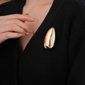 Detail of a gold teardrop brooch on black knitwear showing a minimalist metal texture - Gold Waterdrop