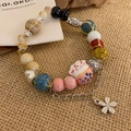 Detail of handmade ceramic bead bracelet with pink lucky cat charm and metal flower pendant - 5# Multi-color Cat