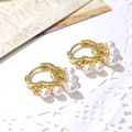 Detail of gold heart-shaped hoop earrings with elegant four-pearl tassel drop accents - Gold 5-Pearl Style