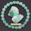 Macro detail of green aventurine beaded bracelet with natural stones on black background - Green Aventurine