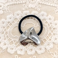 Minimalist black elastic hair tie featuring an irregular silver heart metal charm - Silver Hammered Heart