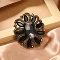 Vintage gold flower brooch with black rhinestones and dark grey crystal centerpiece - Black