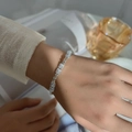 Elegant silver bracelet with rectangular clear zircons worn on wrist in lifestyle setting - Double Row White