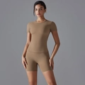 Detail of light brown quick-dry yoga set featuring tight t-shirt and high waist cycling shorts - S / Cocoa
